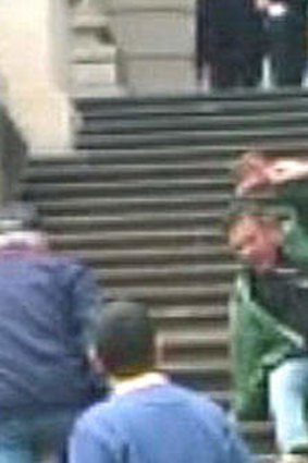 Geoff Shaw allegedly punching a taxi protester on the steps of Parliament House.