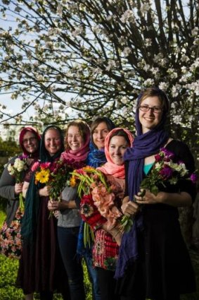 With love: Rebecca Bull, Kirrily Burnett, Eliza Spencer, Annabelle Lee, Gemma White and Hannah Dungan wore hijabs and gave out flowers at a Islamic service on weekend at a Muslim service.