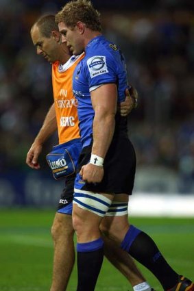David Pocock of the Force is assisted from the field after injuring his knee during the round three match against the Sharks.