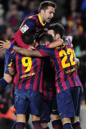 Barcelona's forward Pedro Rodriguez (unseen) is congratulated by his teammates after scoring against Malaga CF.