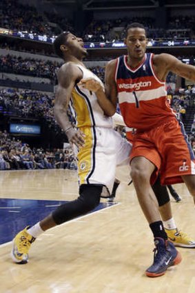 Washington Wizards forward Trevor Ariza, right, moves into Indiana Pacers forward Paul George.