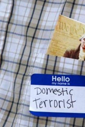 A Cliven Bundy supporter proudly wears a ''domestic terrorist'' nametag. 