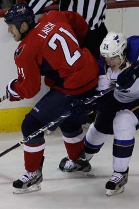 T.J. Oshie of the St. Louis Blues goes after his man against Washington.