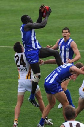 North Melbourne's Majak Daw flying over the pack to take a mark in the practice game against Hawthorn in Cragieburn, 16th March.