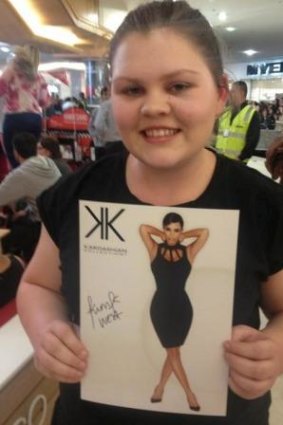 Georgia Mills, 15, scores an autographed picture.