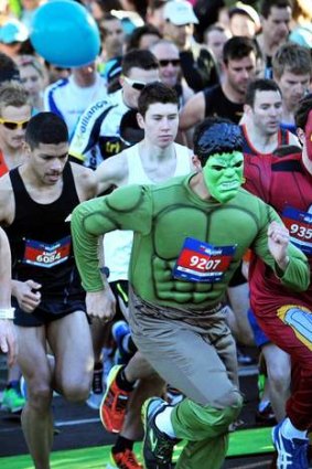 Thousands of runners make their way around the circuit, including The Hulk and Iron Man.