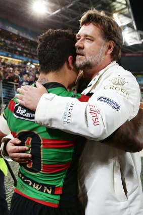 Winning: Issac Luke embraces Rabbitohs part owner Russell Crowe after the First Preliminary Final.  