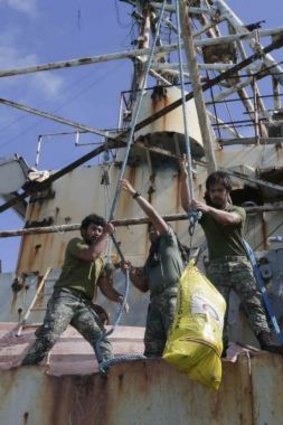 Philippines Marines load supplies onto the Sierra Madre after the supply vessel successfully ran China's attempted blockade.