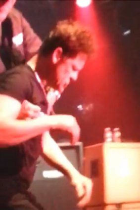 Ex-Metallica musician, Jason Newsted, being pulled back onstage after being pushed from behind during a New York gig.