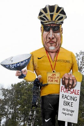 British artist Frank Shepherd of the Edenbridge Bonfire Society puts the finishing touches to a giant effigy of US cyclist Lance Armstrong.
