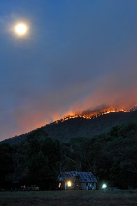 A line of fire rises over the Bungalow Spur behind Harrietville.