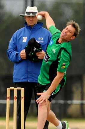 Shane Warne bowls during a practice match on Monday.