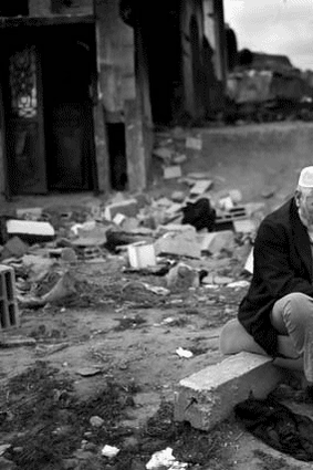 Niam Mirdi, 63, sits in front of his destroyed home in the village of El Atatra, Gaza.