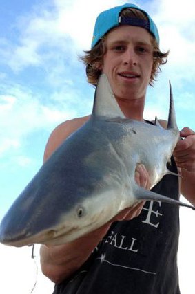 Henry Phillips with the bull shark he caught.