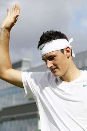 Bernard Tomic celebrates his victory over Nikolay Davydenko.