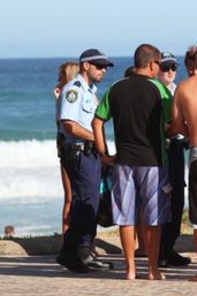 Police talk to witnesses at Redhead Beach, near Newcastle.