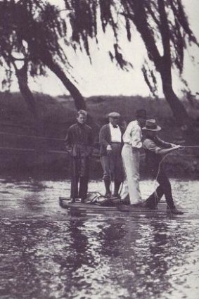 The game must go on: Crossing the Molonglo River on a pontoon to get to complete a round of golf at the original Royal Canberra Golf Club circa 1934.