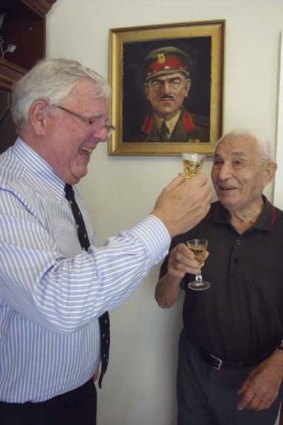 Time for celebration ... Bruce Hayman (left) and Giuseppe Tizzone share a toast in front of a portrait of Major George Hayman.