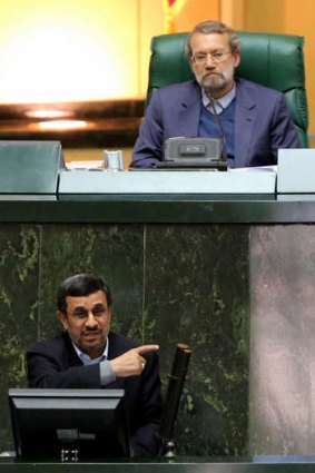 Ali Larijani ... the former Iranian Parliament Speaker (top) listens to Iranian President Mahmoud Ahmadinejad.