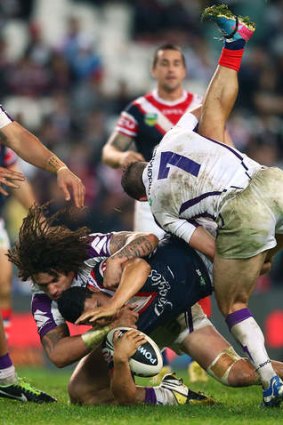 Downed: Cooper Cronk upends Roger Tuivasa-Sheck.