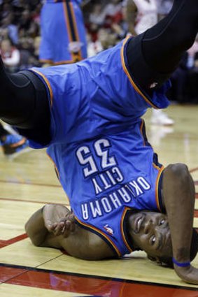 Oklahoma City Thunder's Kevin Durant flips on his head after being fouled by Houston Rockets opponent Aaron Brooks.