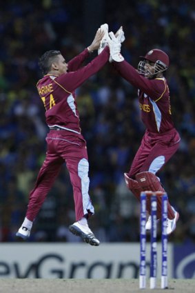 West Indies' Sunil Narine, left, celebrates with teammate Denesh Ramdin after taking the wicket of Sri Lanka's Nuwan Kulasekara.