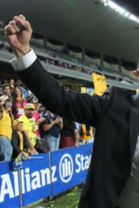 Victory salute: Mariners coach Graham Arnold celebrates after his team's grand final triumph on Sunday.