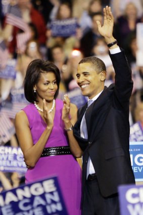 Michelle Obama applauds her husband Barack after his speech.