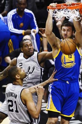 Take that: Andrew Bogut slams home two points against the San Antonio Spurs.