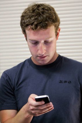Wrong message ...  Facebook CEO Mark Zuckerberg checks his phone.
