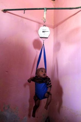 Baby Mohammad being weighed at Red Crescent.