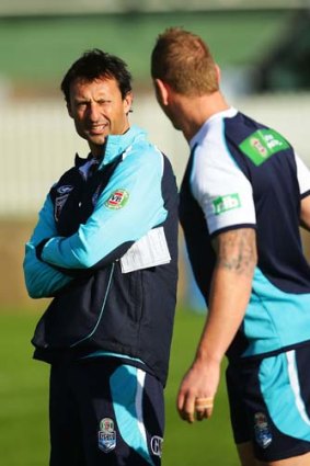 NSW Blues coach Laurie Daley talks to Luke Lewis during a training session at Coogee Oval on Thursday.