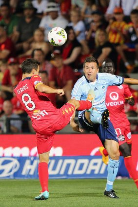 Calisthenics: Adelaide's Isaias Sanchez battles for the ball with Sydney FC's Milos Dimitrijevic.