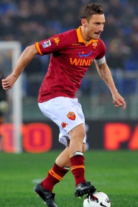 Francesco Totti controls the ball during Serie A match against Genoa.
