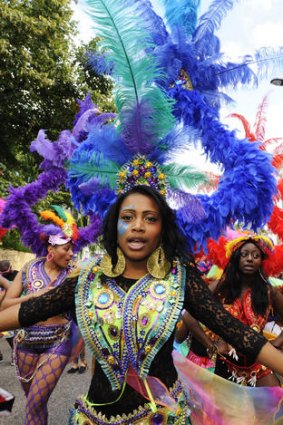 Dancers in exotic costumes perform in the Notting Hill Carnival.