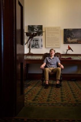 Angus Brodie sits in the chair his ancestor, Gerard Krefft, was seated in when he was physically removed from the Australian Museum by two prizefighters in 1874.