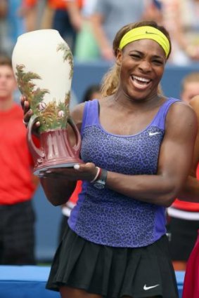 Serena Williams holds the winner's trophy after beating Ana Ivanovic of Serbia 6-4, 6-1.