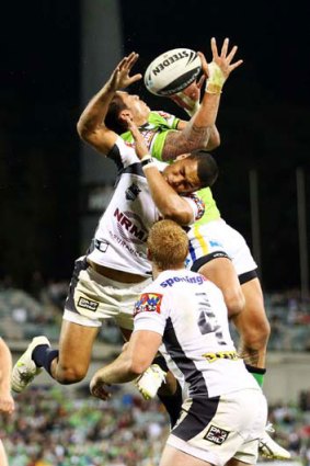 Jharal Yow Yeh of the Broncos and Daniel Vidot of the Raiders contest a high ball.