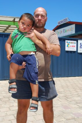 John McAlister and his son Oliver outside the LIttle Rascals Child Care Centre from which he escaped.