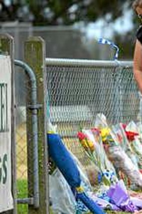 Friends arrive at the Tyabb oval to place flowers near the scene where Luke Batty was killed by his father.