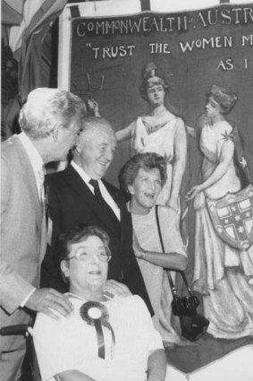 Hall presents a women's suffrage banner to the prime minster Bob Hawke, and wife Hazel, in 1988.