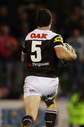 No looking back: Penrith's Dave Simmons breaks away to score for Penrith against the Storm.