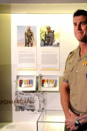Victoria Cross recipient Corporal Ben Roberts-Smith pictured with his newly installed panel and medal display in the Hall of Valour, at the Australian War Memorial in 2011.