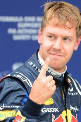 Red Bull's Sebastian Vettel gestures after snaring pole position.