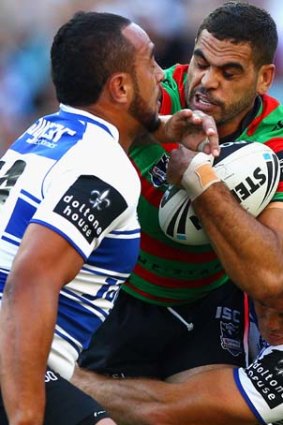 Collision ... Greg Inglis of the Rabbitohs is tackled by Sam Kasiano.