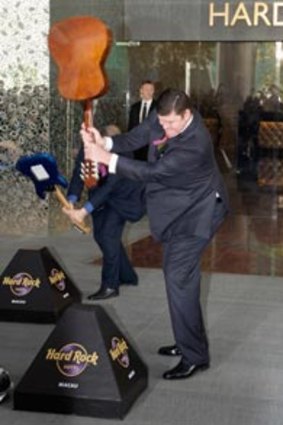 Smashing to do business with  ... James Packer does his best Pete Townshend impersonation at the Hard Rock Hotel opening ceremony, during the launch festivities for his and Lawrence Ho’s City of Dreams casino in Macau on June 1.