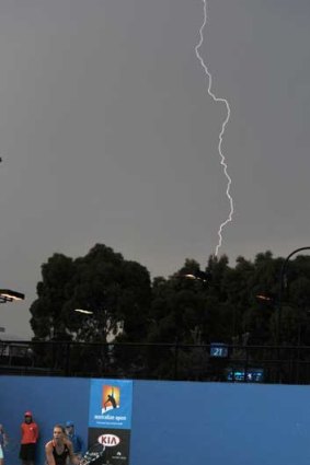 Lightning strikes as play continues on court 22 at the Australian Open.
