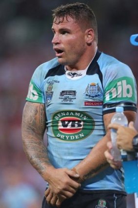 Anthony Watmough of the Blues holds his injured arm on Wednesday night.