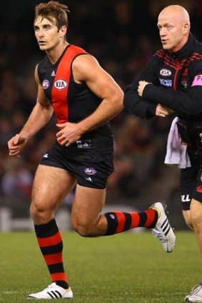 Jobe Watson leaves the ground after a  bump from Justin Westhoff.