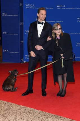 Carrie Fisher with Tom Hiddleston and her dog Gary at the 102nd White House Correspondents' Association Dinner in April. 